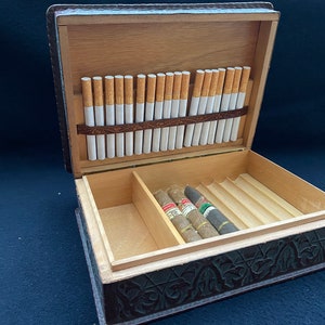A beautiful cigar and cigarette storage box, covered in embossed leather.