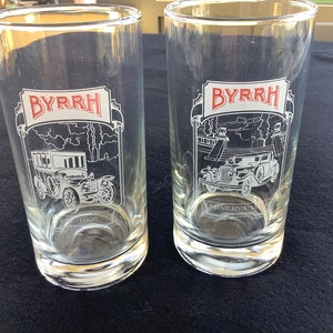 May include: Two clear glass tumblers with a white design of vintage cars and the text "BYRRH" in red. One glass features a "MINERVA" car and the other features a car from 1908.