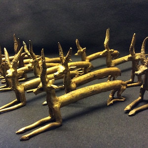 vintage set of 12 African bronze knife rests inspired by  resting gazelles, antilopes,  made with lost wax method, handmade