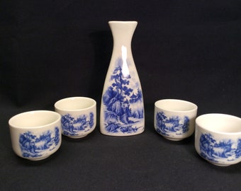 Vintage of Japan, Japanese blue landscape, a 5 piece Sake set. Sake bottle with blue landscape with 4 sake drinking cups.