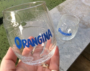 2 vintage Orangina glasses as a peeled orange in relief, Orangina written in bottom
