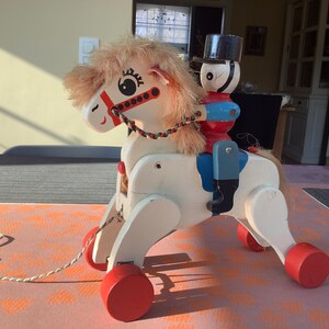 Vintage wooden toy draft horse with soldier, dating from the 1960s.