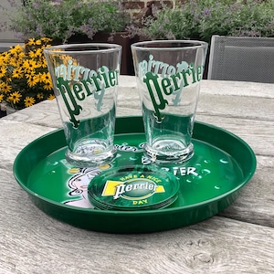 A vintage  metal Perrier Green Classic  round Serving Tray, Pub Deco,  classic Perrier logo with two large  Perrier glasses and 6 coasters