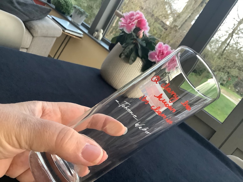 May include: A clear glass with the text "A very special hug" and "to cherish" written in red ink. The text is signed "Johanne Walter".