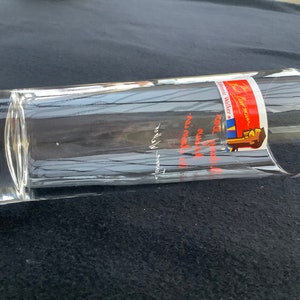 May include: A clear glass tumbler with a red, white, and blue label that reads "Johnnie Walker Red Label" and "Keep Walking".