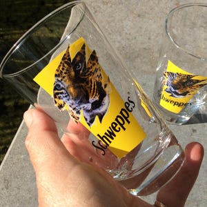 2 vintage Schweppes glasses,  Indian Tonic glasses longdrink glass, with the head of a panther in the classic schweppes logo