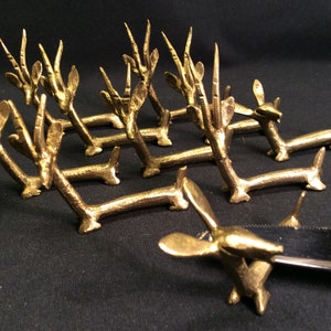 vintage set of 12 African bronze knife rests inspired by  resting gazelles, antilopes,  made with lost wax method, handmade