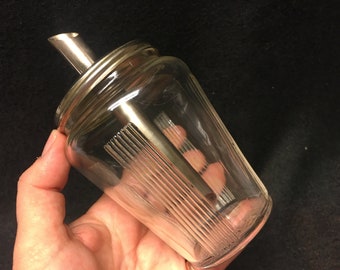 A vintage sugar dispenser/shaker and honey or creamer dispenser set Design, from corn Drost, Rhenen Holland