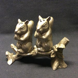 Vintage metal Salt Pepper shaker squirrel, sitting on a branch, eating a nut, acorn, lovely at the diner table