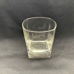 May include: A clear glass tumbler with a square base. The glass has the words "KEEP WALKING" etched on the side.