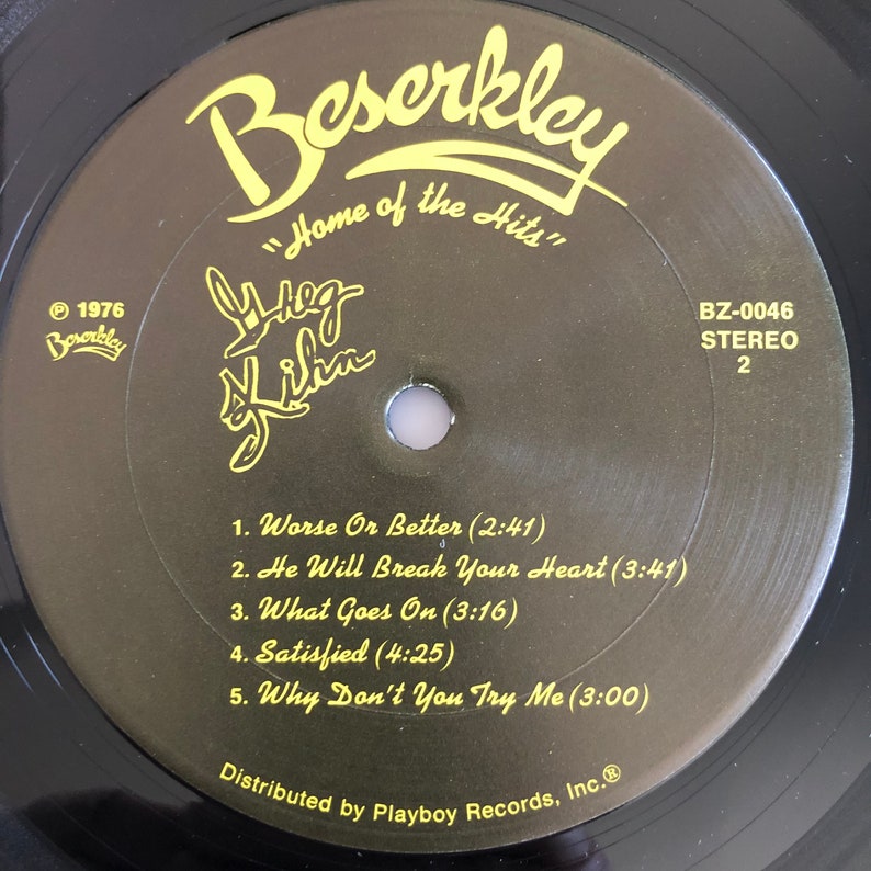 Op de afbeelding: Een zwarte vinylplaat met een geel label. Het label heeft de tekst "Beserkley" in een geel cursief lettertype, "Home of the Hits" in gele tekst en de tekst "Meg Griffin" in een geel cursief lettertype. Het platenlabel bevat ook de tekst "BZ-0046 STEREO 2" en een lijst met songtitels met hun bijbehorende lengtes.