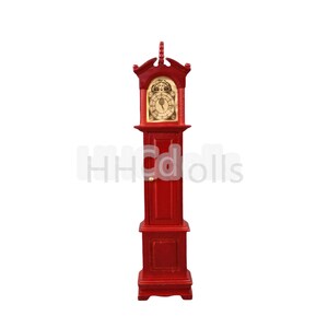 May include: A red wooden grandfather clock with a gold face and hands. The clock has a small door on the front and a decorative top.