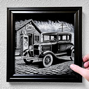 May include: Black and white framed print of a vintage car parked in front of a Shell gas station. The artwork is a detailed illustration with a classic car and gas pump. The Shell sign reads "Shell 90".