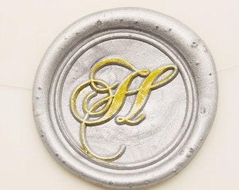 May include: A silver wax seal with a gold letter H in a decorative script font.