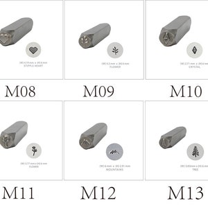 May include: Set of 6 metal stamping tools for jewelry making. Each tool features a different design, including a heart, flower, crystal, mountain, and tree. The tools are approximately 6 mm in width.