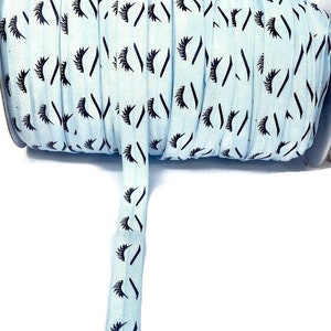 PALE Blue Eyelash- Fold over elastic, FOE, ribbon, stretch - lash, lashes, eyelash- mascara, pale blue background with black eyelashes