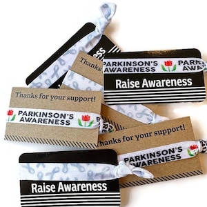Lazos de concientización sobre el Parkinson -Lazos con antecedentes de cáncer blanco aumentan la concientización Gracias por su tarjeta de apoyo- Regalo de lazos para el cabello con pulsera de banda elástica