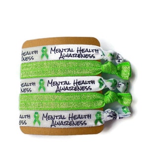 May include: Set of three green and white hair ties with the text "Mental Health Awareness" and a green ribbon.