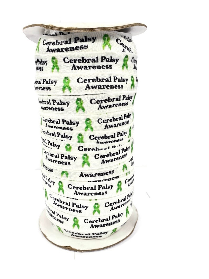 May include: A spool of white ribbon printed with "Cerebral Palsy Awareness" in black text and a green awareness ribbon graphic. The ribbon is tightly wound on a cardboard spool, ready for use in crafts or awareness campaigns.