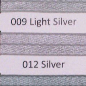 May include: Close-up of two fabric samples, one light silver and one silver, with corresponding product codes and names: "009 Light Silver" and "012 Silver".
