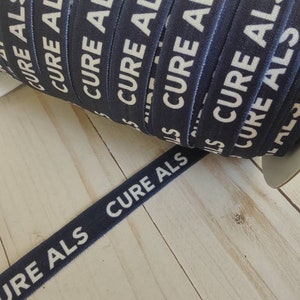 May include: A roll of navy blue elastic ribbon with the words "Cure ALS" printed in white.