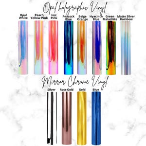 May include: A selection of holographic and mirror chrome vinyl rolls in various colours, including opal white, peach yellow, hot pink, peacock blue, beige orange, hyacinth blue, green malachite, matte silver rainbow, silver, rose gold, gold, and blue.