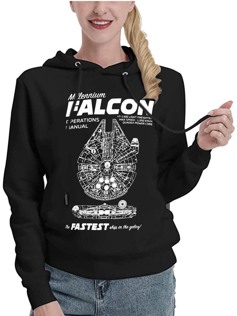 May include: Black hooded sweatshirt with a white graphic of the Millennium Falcon spaceship. The graphic includes the text "Millennium Falcon", "YT-1300 Light Freighter", "Max Speed: 1,050 km/h", "Quadrex Power Core", and "The Fastest ship in the galaxy!"