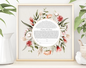May include: A framed wedding ketubah with a gold border. The ketubah features a floral wreath design with red, pink, and beige flowers, and green leaves. The names "Rachael & David" are printed in the center, with text below.