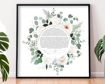 May include: A framed wedding ketubah with floral and botanical accents. The artwork features a circular design with white peonies, green foliage, and text in both English and Hebrew. The frame is black.
