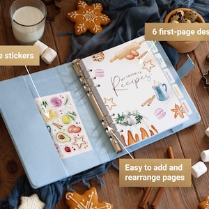 May include: A light blue ring-bound recipe binder featuring a cover page with the text "MY FAVORITE Recipes" and watercolor illustrations of baking ingredients. The binder includes a sheet of stickers and tabbed dividers for organization.