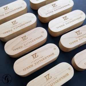 Puede incluir: Memorias USB de madera con el texto "JZ АГЕНТСТВО ИРИНЫ ЗАГРАНИЧНОЙ" grabado en cada una.