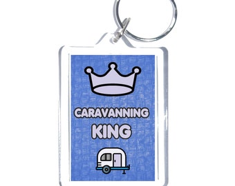 May include: A blue and white keychain with a crown and the text "Caravanning King" and a cartoon image of a camper.