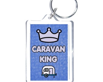 May include: A blue and white keychain with a crown, the text "CARAVAN KING", and a cartoon image of a camper.