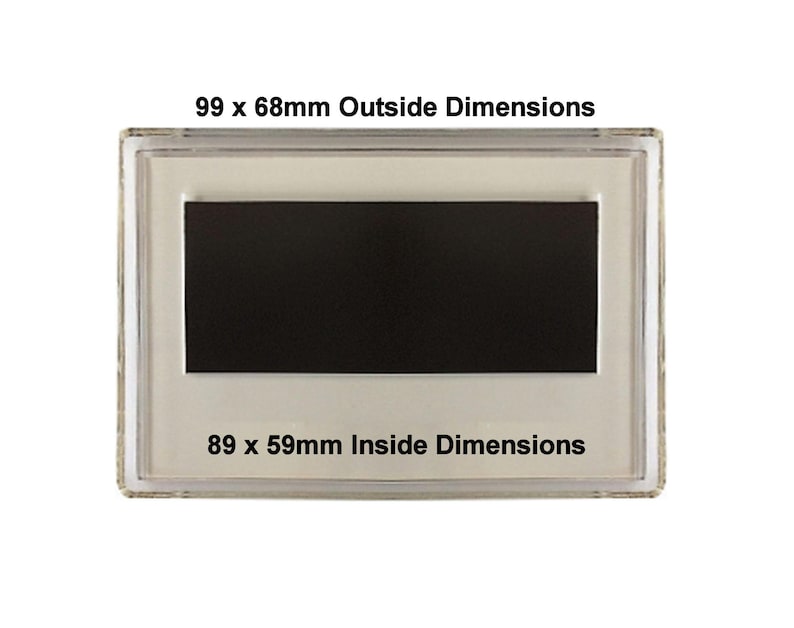 May include: A clear plastic frame with a black rectangular magnet inside. The frame has the text "99 x 68mm Outside Dimensions" and "89 x 59mm Inside Dimensions" printed on it.