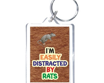 May include: A brown and white key chain with a rat illustration and the text "I'm Easily Distracted By Rats".