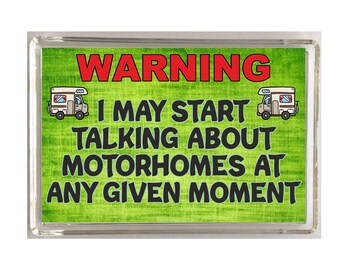 May include: A green and white warning sign with a cartoon motorhome on each side. The sign reads "WARNING I MAY START TALKING ABOUT MOTORHOMES AT ANY GIVEN MOMENT."