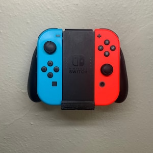 May include: A blue and red Nintendo Switch Joy-Con controller with black straps and a black center piece. The controller has the Nintendo Switch logo and the words "NINTENDO SWITCH" printed on it.