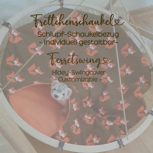 May include: A ferret swing with a brown cover featuring orange fox illustrations. The swing has a peach-colored interior and a white frame. The text "Ferretswing" and "Hidey-Swingcover - Customizable -" are visible.