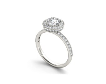 Può includere: Un anello di fidanzamento in argento con una pietra centrale rotonda circondata da un doppio alone di diamanti più piccoli. La fascia è anche incastonata con piccoli diamanti.