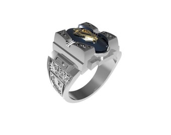 May include: A silver ring with a black stone and a gold design. The ring has intricate details and a unique design.