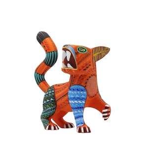 May include: A vibrant, hand-painted wooden cat figurine. The orange body is adorned with intricate patterns in blue, green, and black. The cat has an open mouth, revealing white teeth, and a raised tail. A unique piece of folk art.