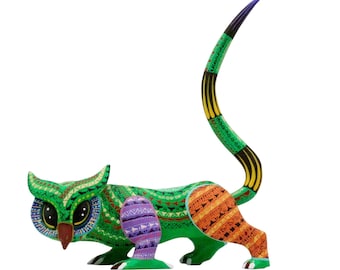 May include: A hand-painted wooden figurine of a hybrid creature with an owl head and a feline body. The figure features a vibrant green base color with intricate geometric patterns in purple, orange, yellow, and black, and a long, curved tail.