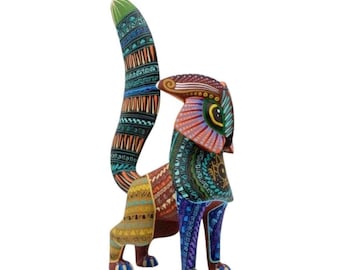 May include: A hand-painted wooden animal figurine featuring a tall, upright tail and a head with large, almond-shaped eyes. The surface is covered in intricate, colorful geometric patterns in shades of blue, orange, yellow, and green.