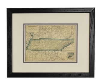 May include: A vintage map of Tennessee, framed in black wood. The map shows the state's counties and major cities, with a green outline of the state's border. The map is titled "Tennessee" and includes a scale bar and compass rose.