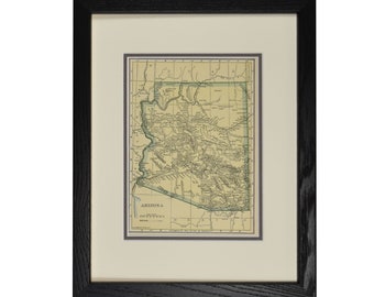 May include: Framed vintage map of Arizona, featuring a detailed depiction of the state's geography. The map is printed on aged paper, framed with a black wooden frame and a cream-colored mat.
