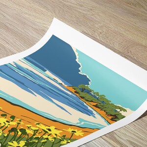May include: A vintage-style travel poster featuring a beach scene with yellow flowers in the foreground, blue ocean waves, a sandy beach, and green trees in the background. The text "Monterey, California" is visible in the bottom left corner.