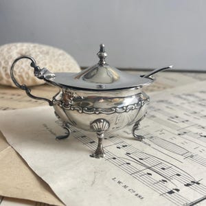 Antik stämplad silverkruka med senapsmotiv från Walker och Hall.