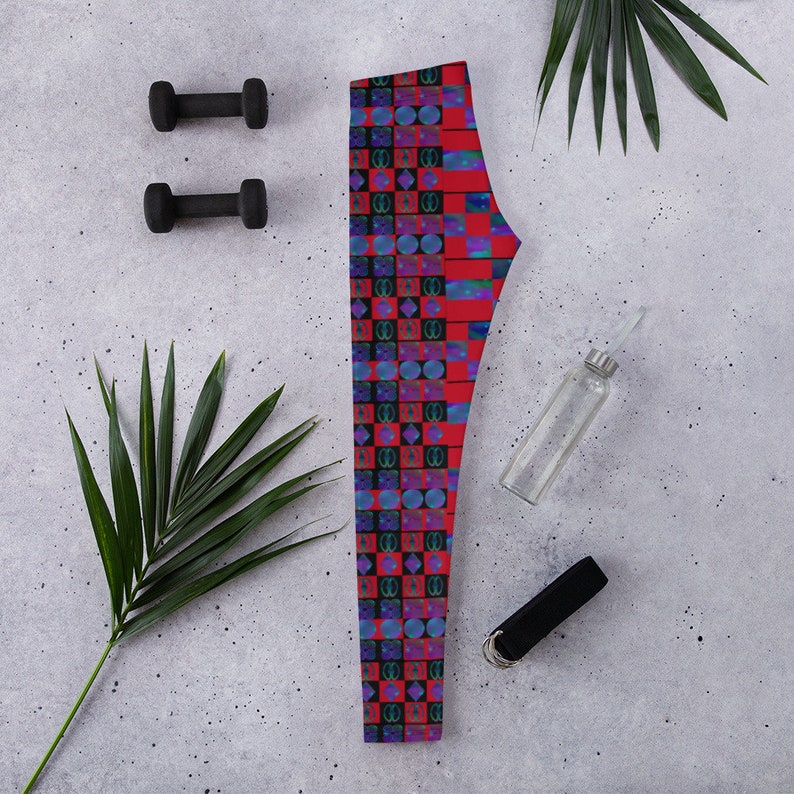 May include: Red leggings with a geometric pattern of blue, black, and white squares and circles.