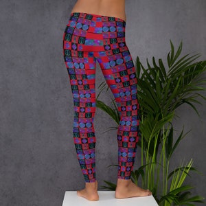 May include: Red leggings with a geometric pattern of blue, green, and black squares and circles.