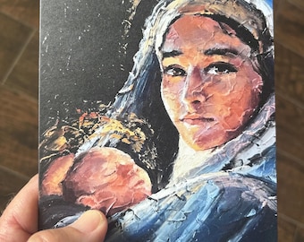 May include: A rectangular art print featuring an oil painting of a person with a head covering holding a sleeping infant. The artwork uses thick, textured brushstrokes in shades of blue, white, orange, and black to depict the figures.